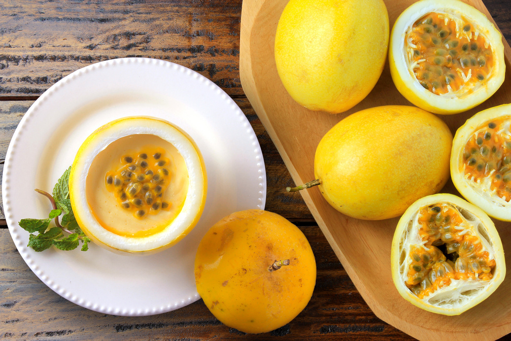 dessert passion fruit mousse in fruit rind on plate decorati